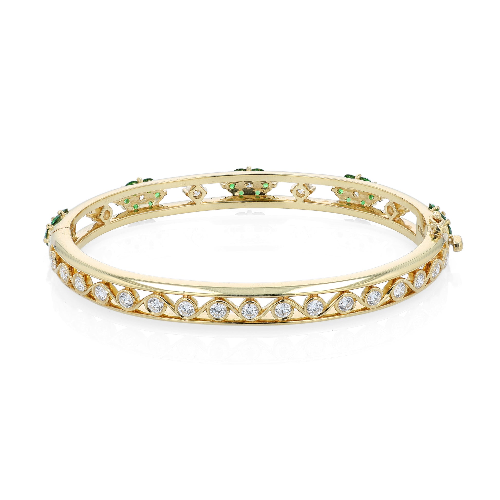 Yellow gold bracelet with green tsavorites and diamond accents on a white background