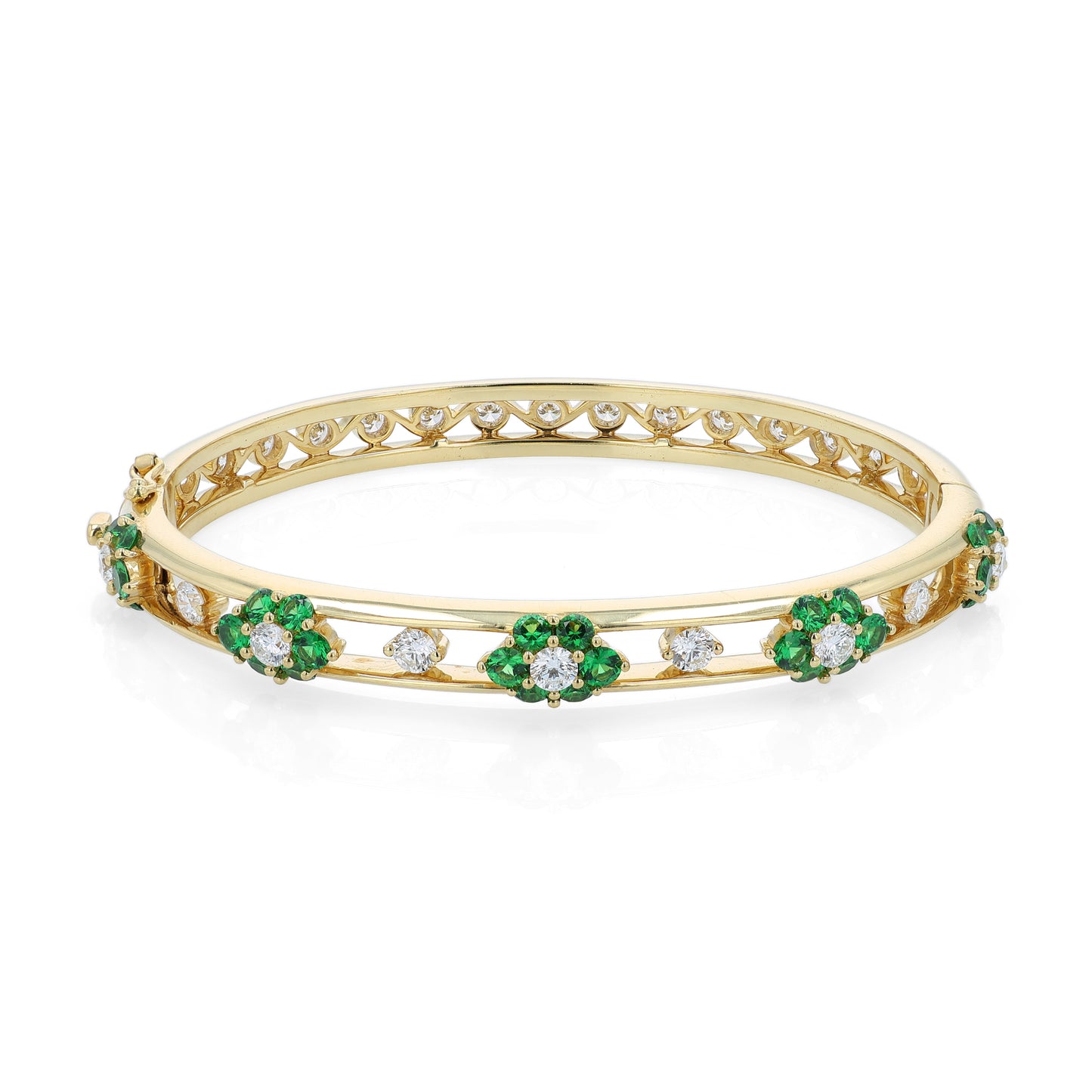Yellow gold bracelet with green tsavorite and diamond accents on a white background