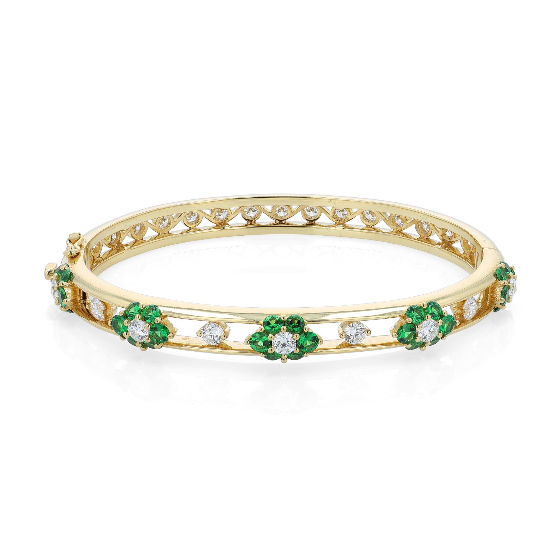 Yellow gold bracelet with green tsavorite and diamond accents on a white background