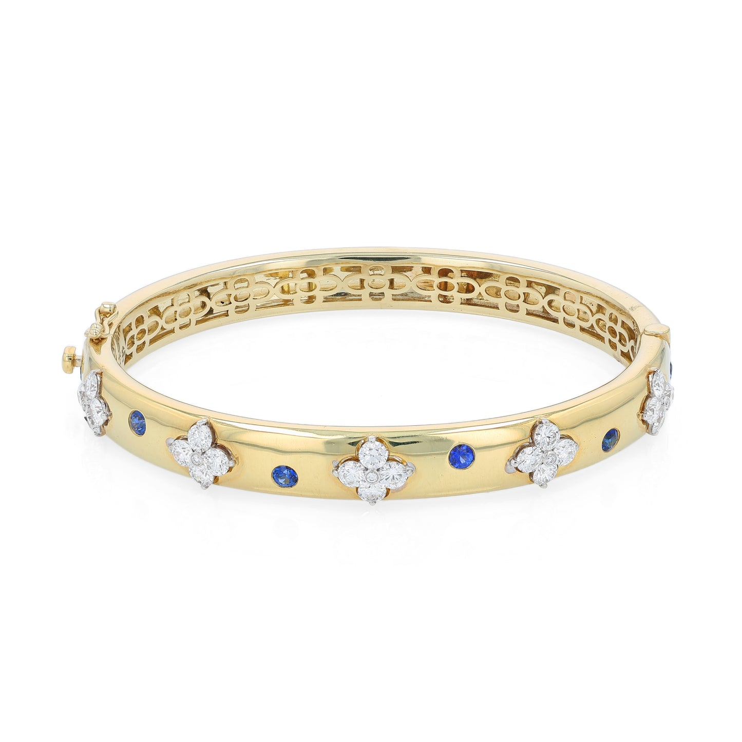 Gold bracelet with diamond and sapphire accents on a white background