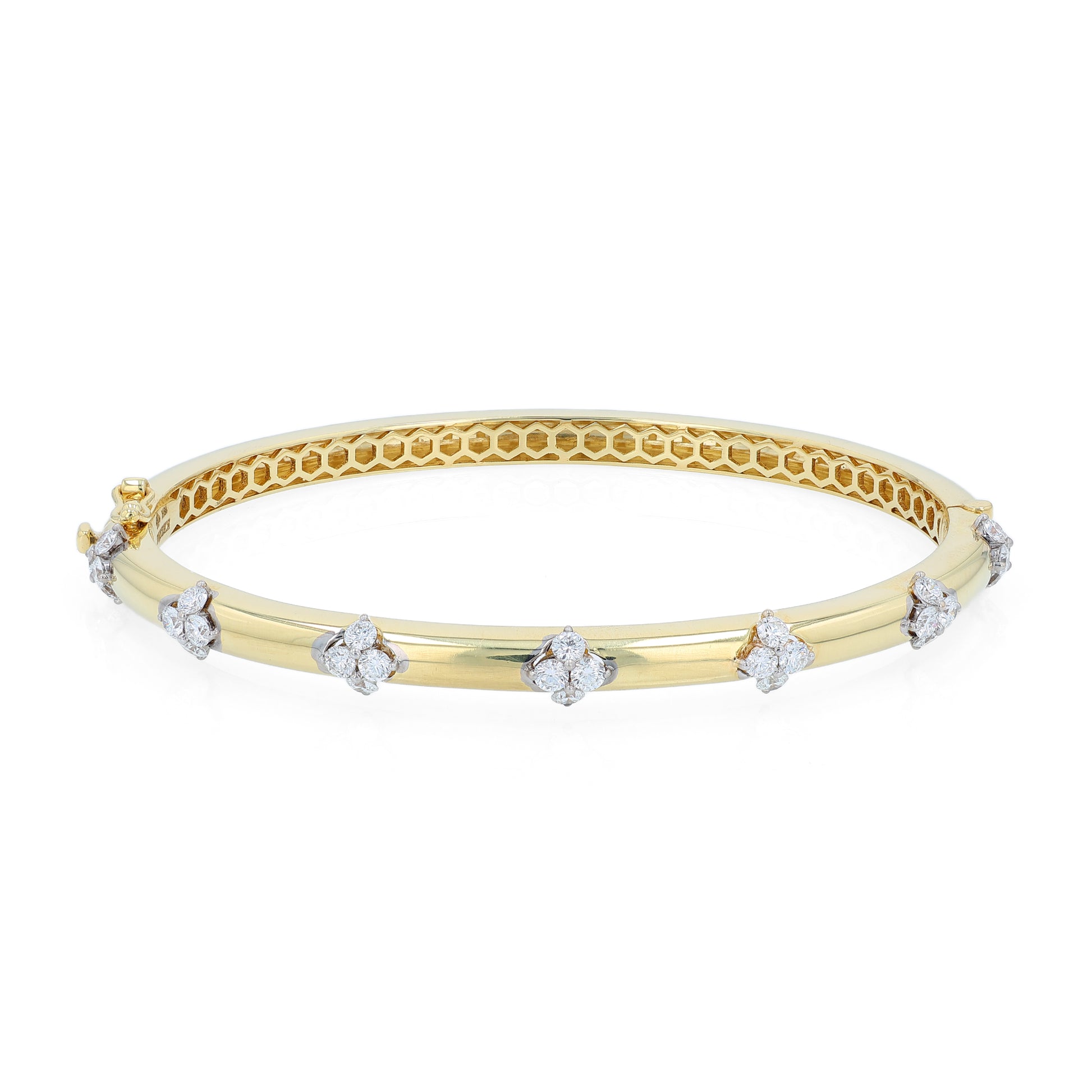 Gold bracelet with diamond cluster accents on a white background