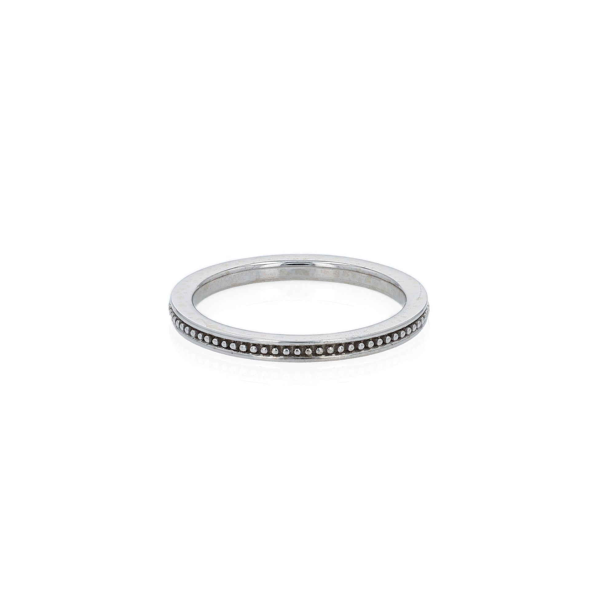 White gold ring with a milgrain center row on a white background