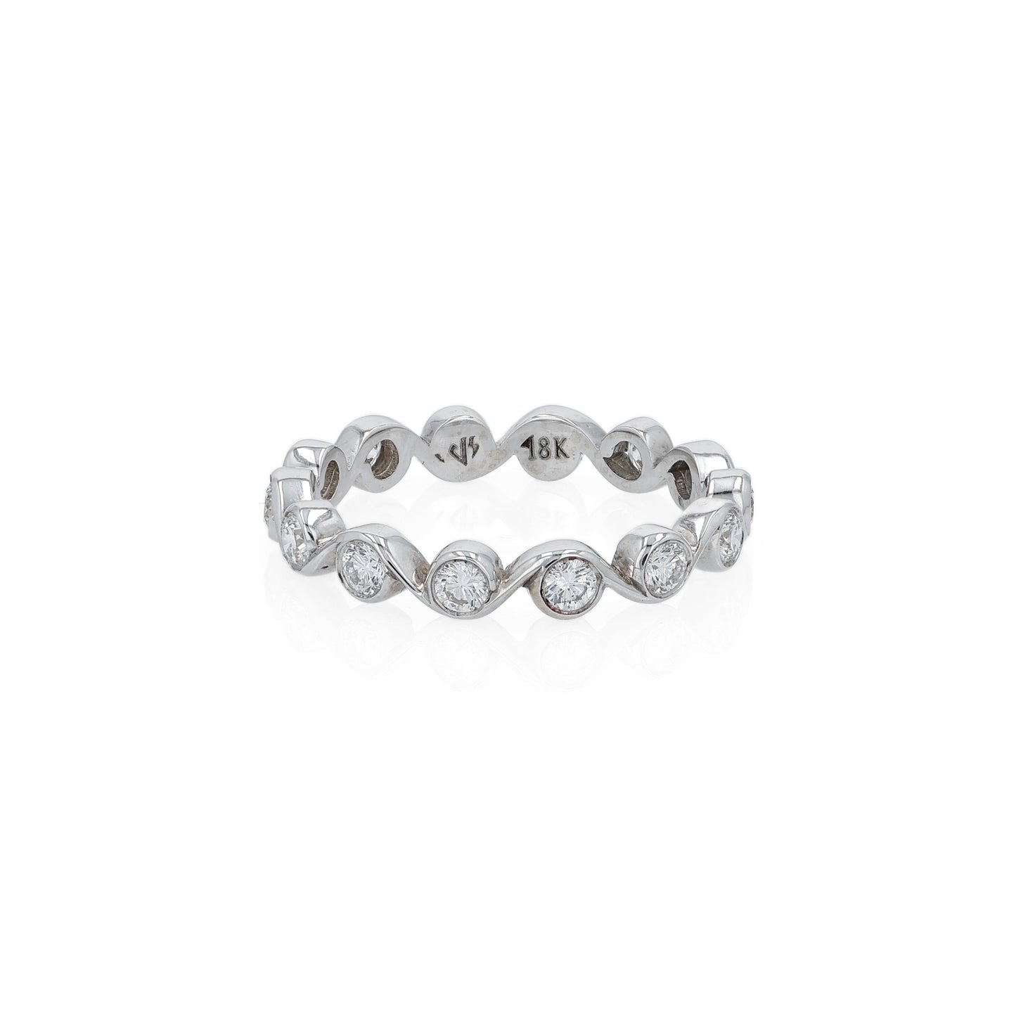 White gold ring with bezel set diamonds on a white background