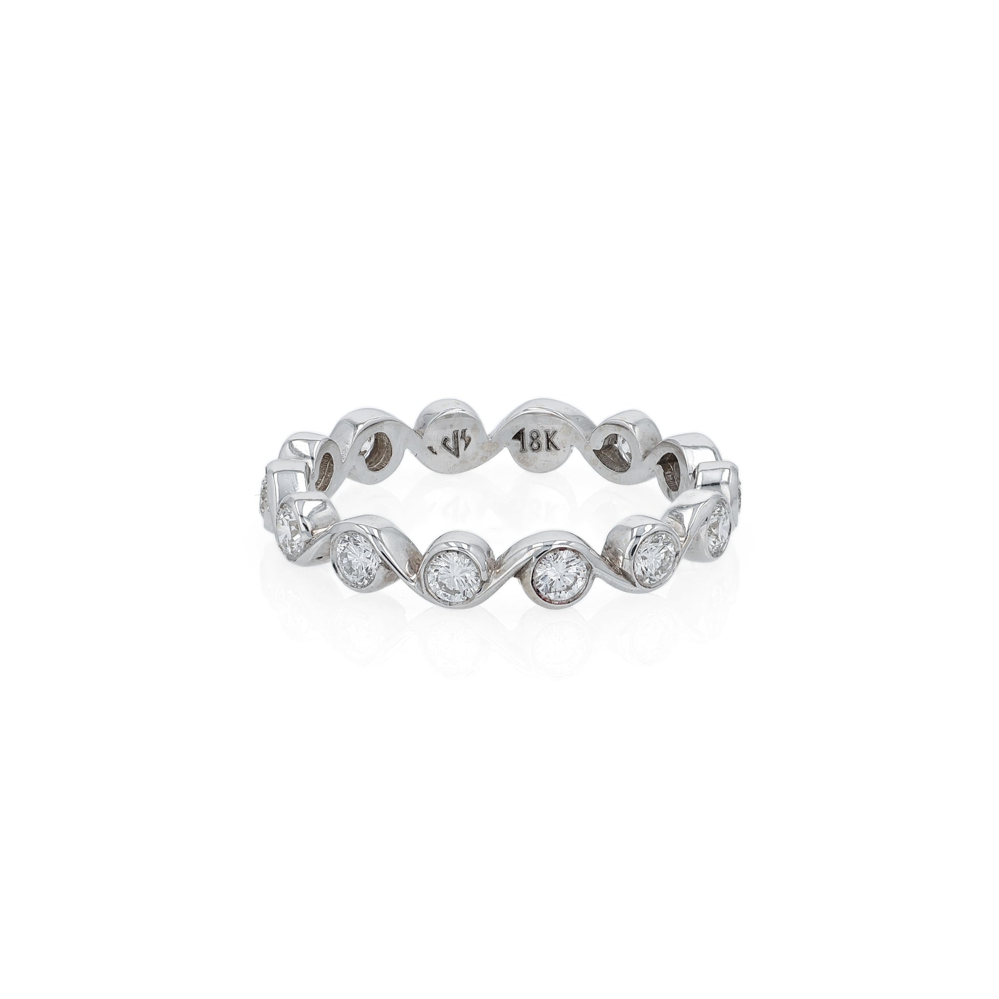 White gold ring with bezel set diamonds on a white background