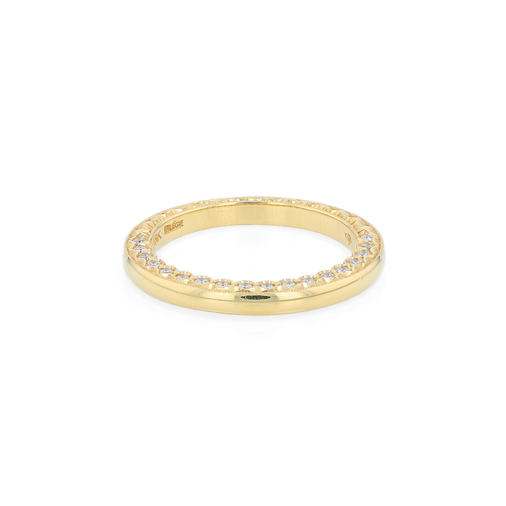 Yellow gold wedding band with diamond accents on a white background