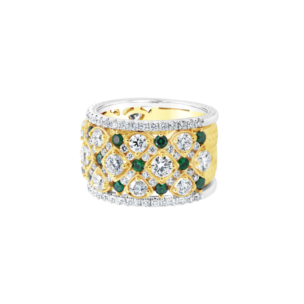 Two-tone ring with green tsavorite and diamond accents on a white background