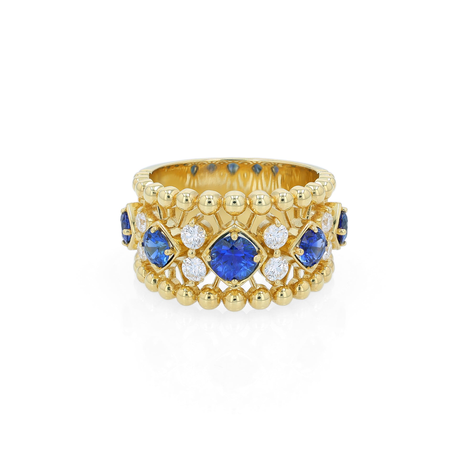 Yellow gold open work ring with diamond and blue sapphire accents on a white background