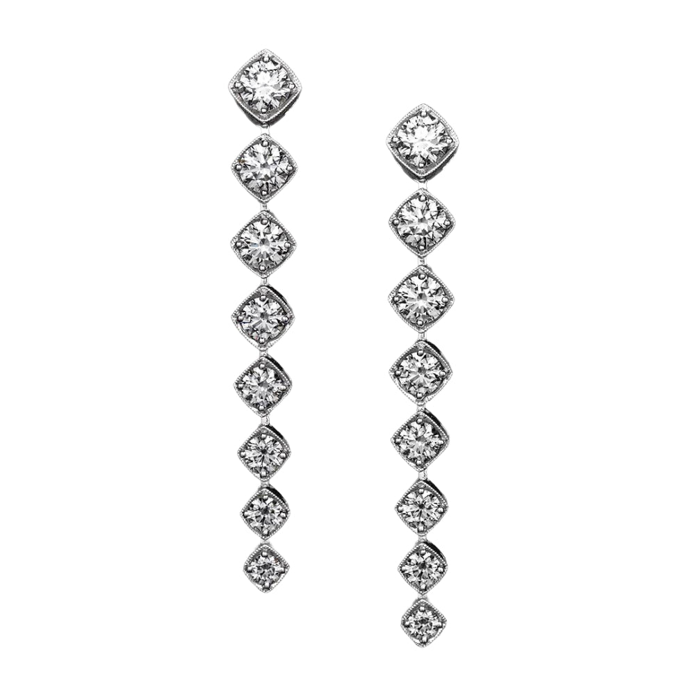 Pair of white gold diamond drop earrings on a white background