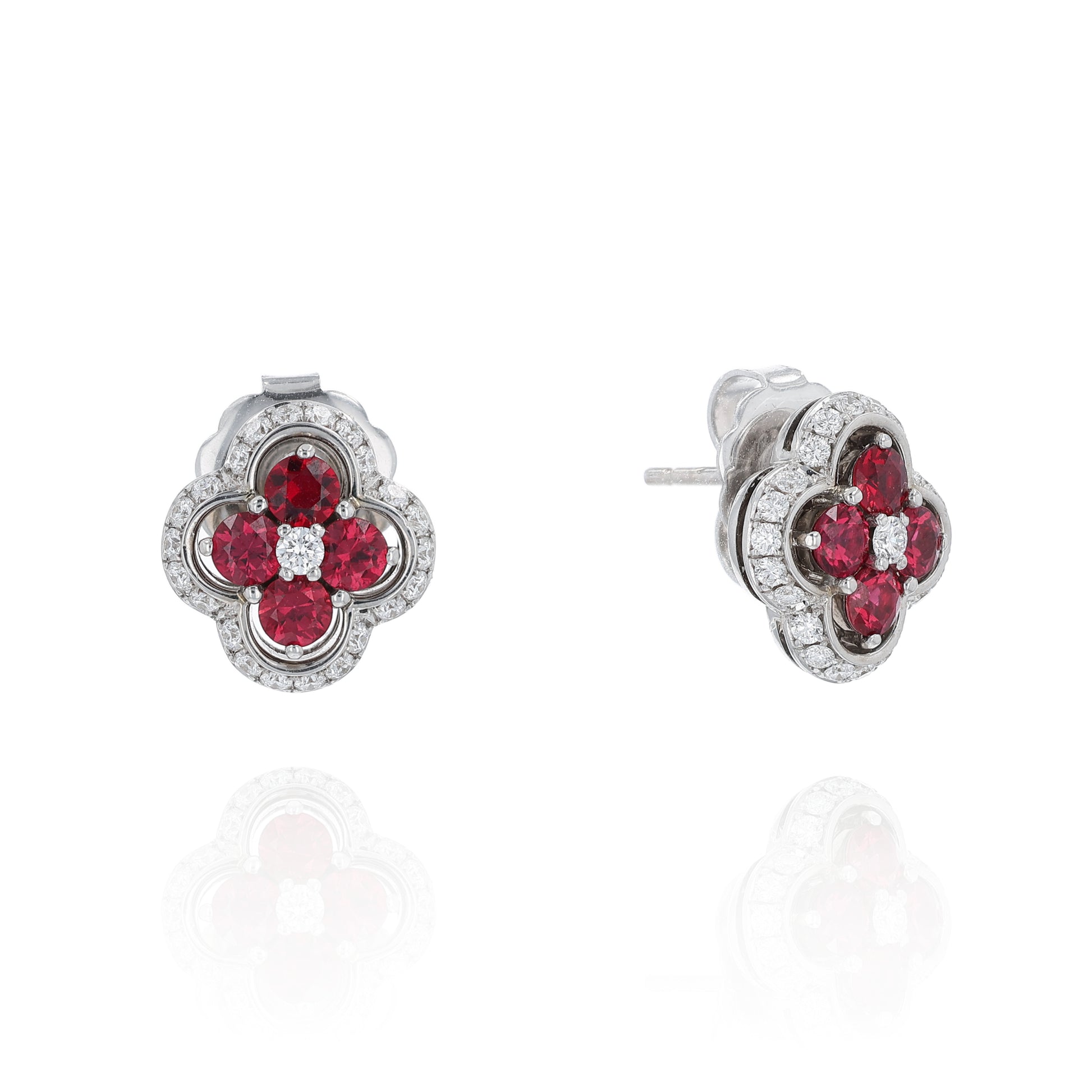 White gold stud earrings with diamond and ruby accents on a white background