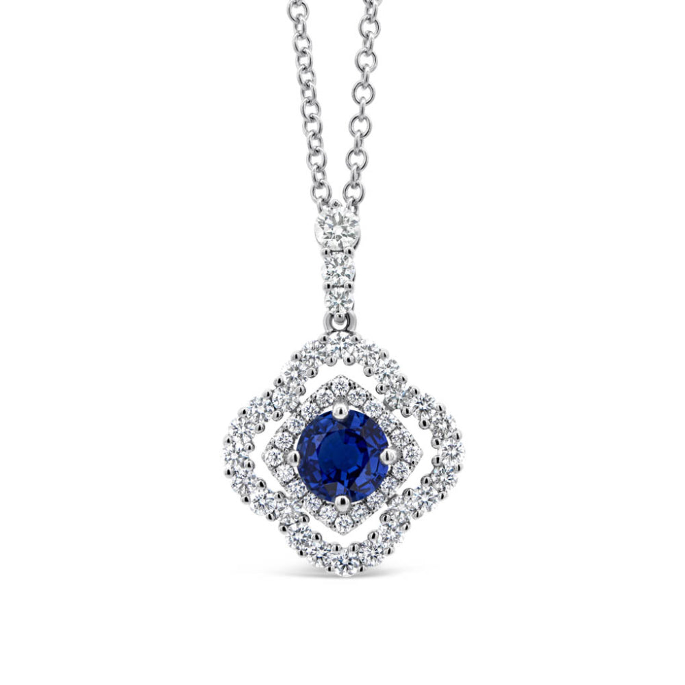 Diamond double halo necklace with a sapphire center on a white background
