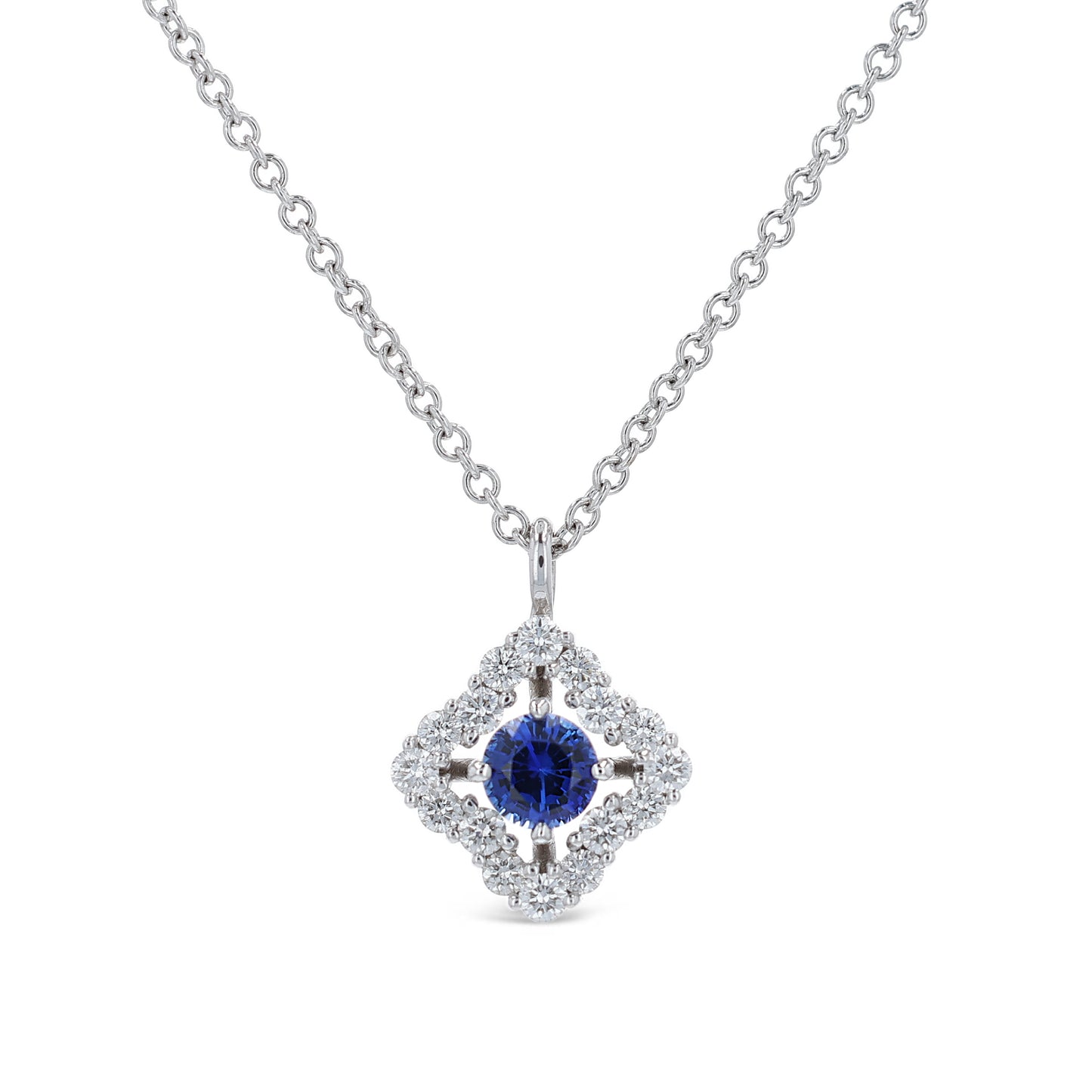 White gold diamond halo pendant necklace with a round blue sapphire center on a white background