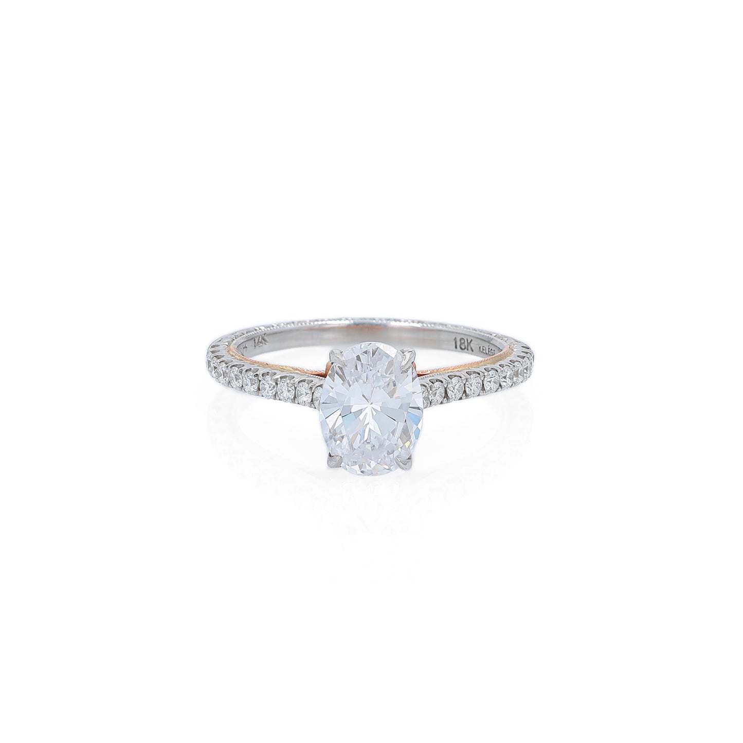 Two-tone gold diamond engagement ring with diamond accents and an oval cubic zirconia center on a white background