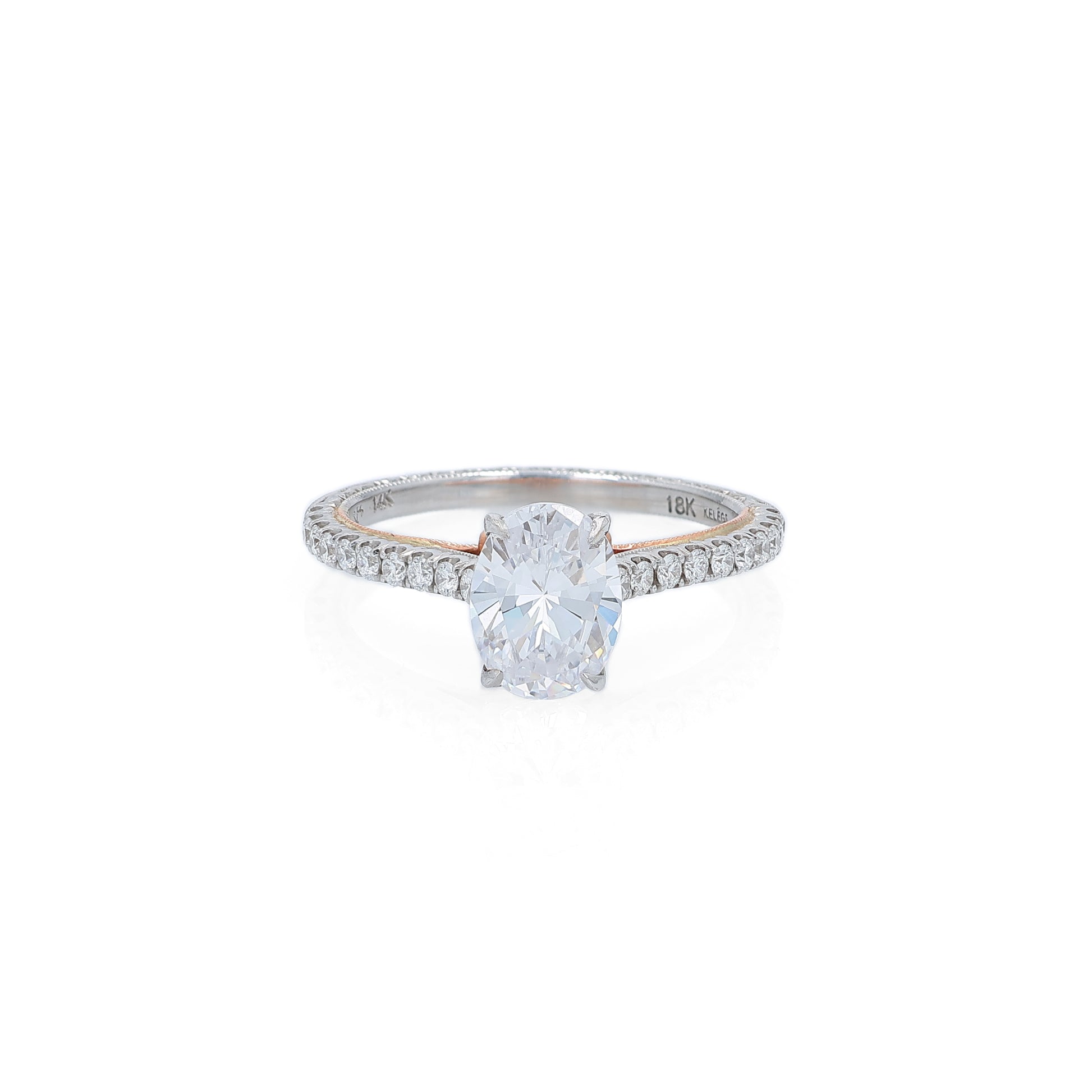 Two-tone gold diamond engagement ring with diamond accents and an oval cubic zirconia center on a white background
