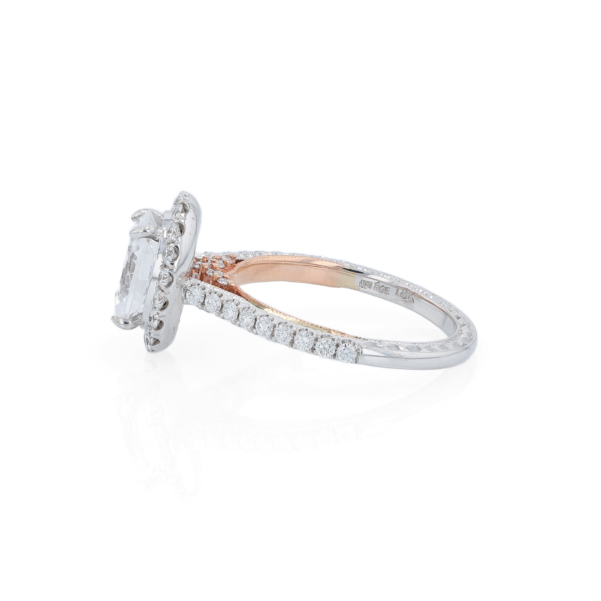 White and rose gold and diamond halo engagement ring with diamond accents and an oval cubic zirconia center on a white background