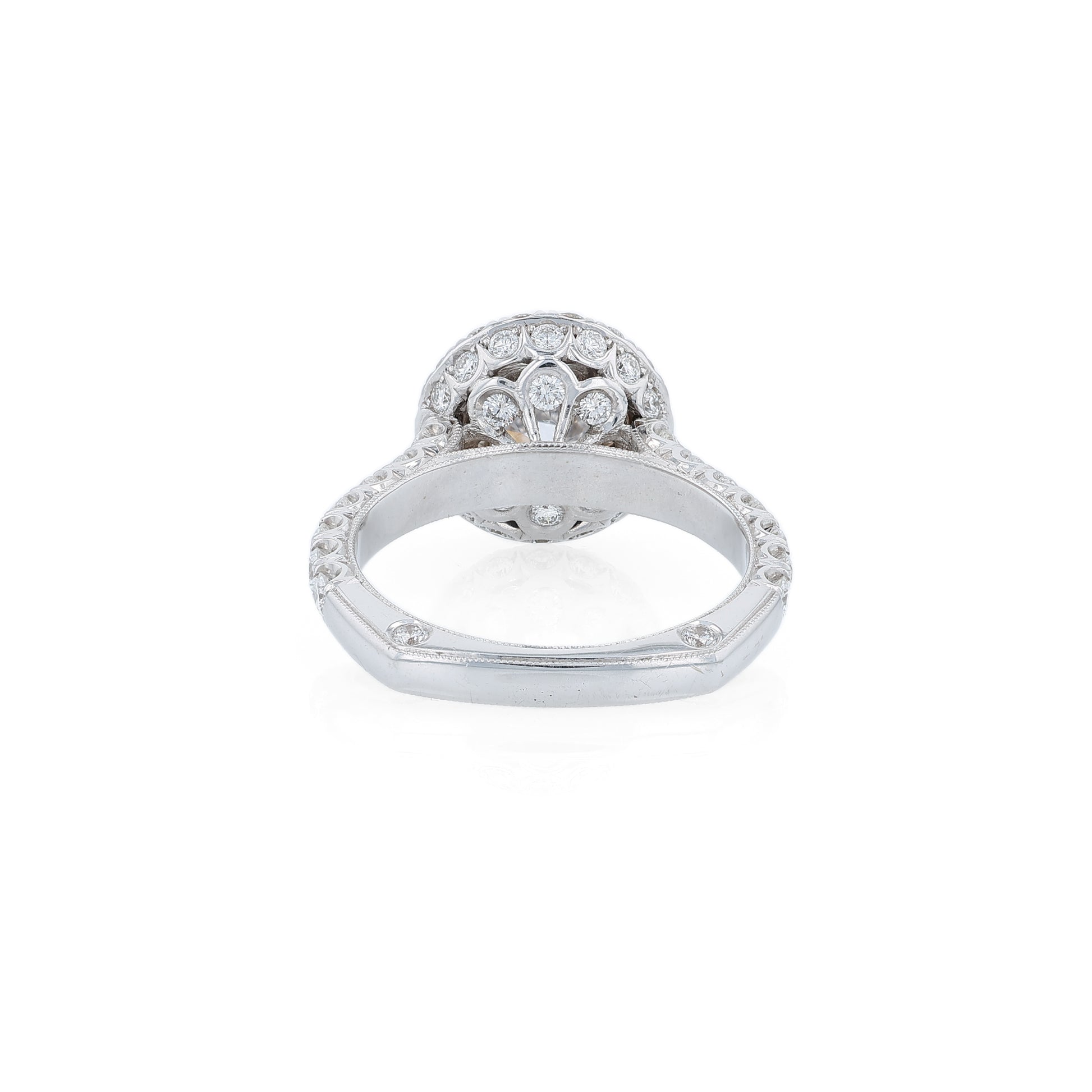 White gold diamond halo engagement ring with diamond accents and a round cubic zirconia center on a white background