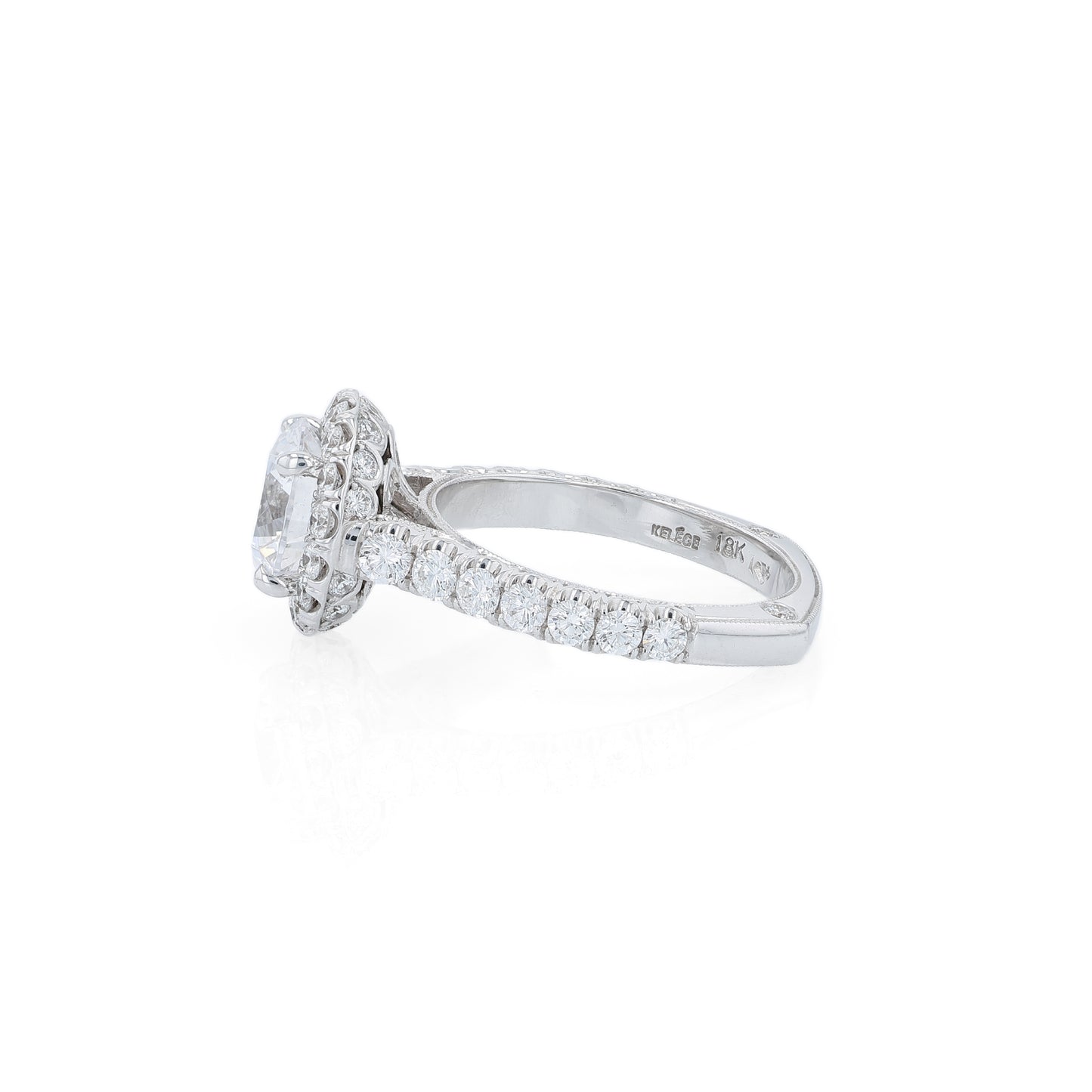 White gold diamond halo engagement ring with diamond accents and a round cubic zirconia center on a white background