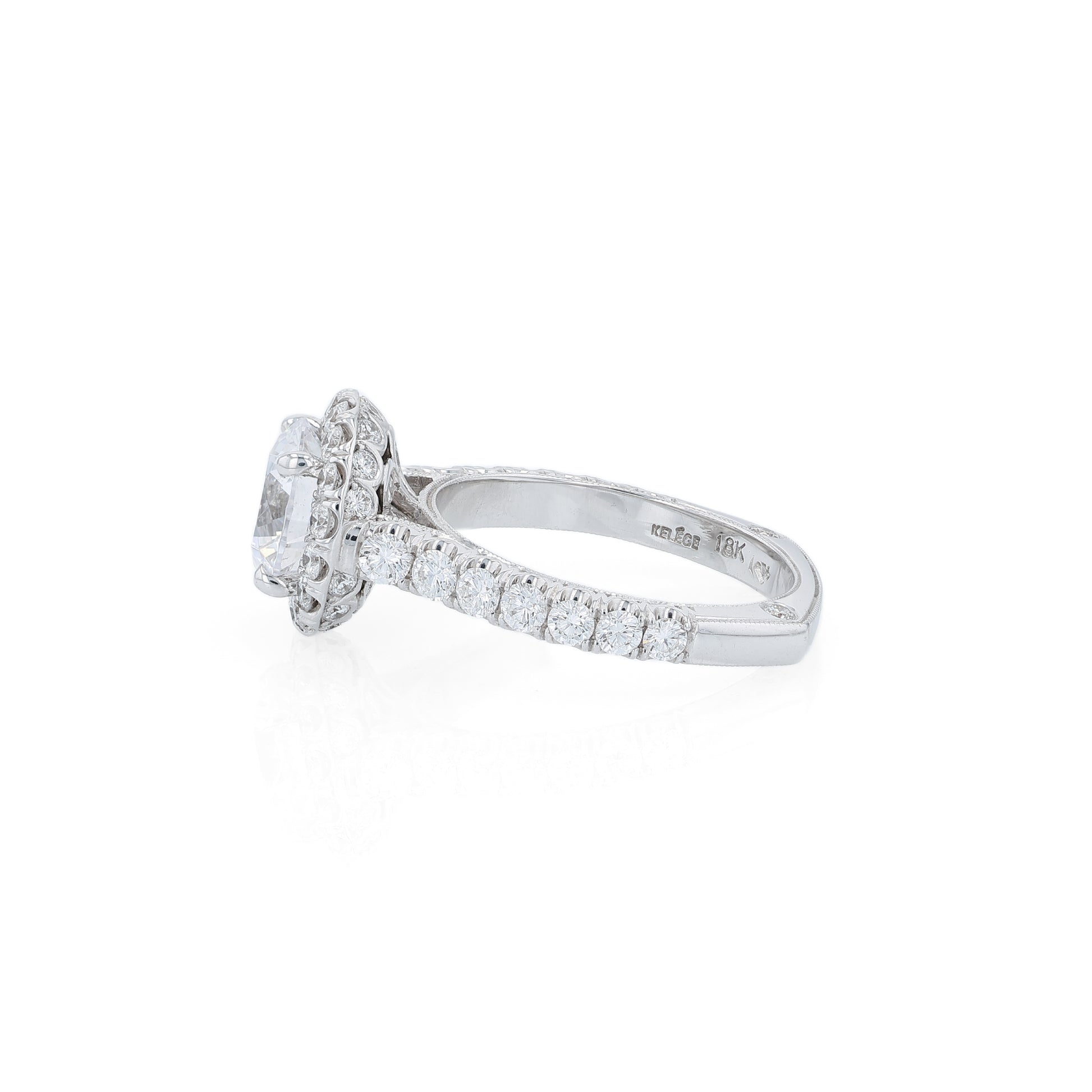 White gold diamond halo engagement ring with diamond accents and a round cubic zirconia center on a white background