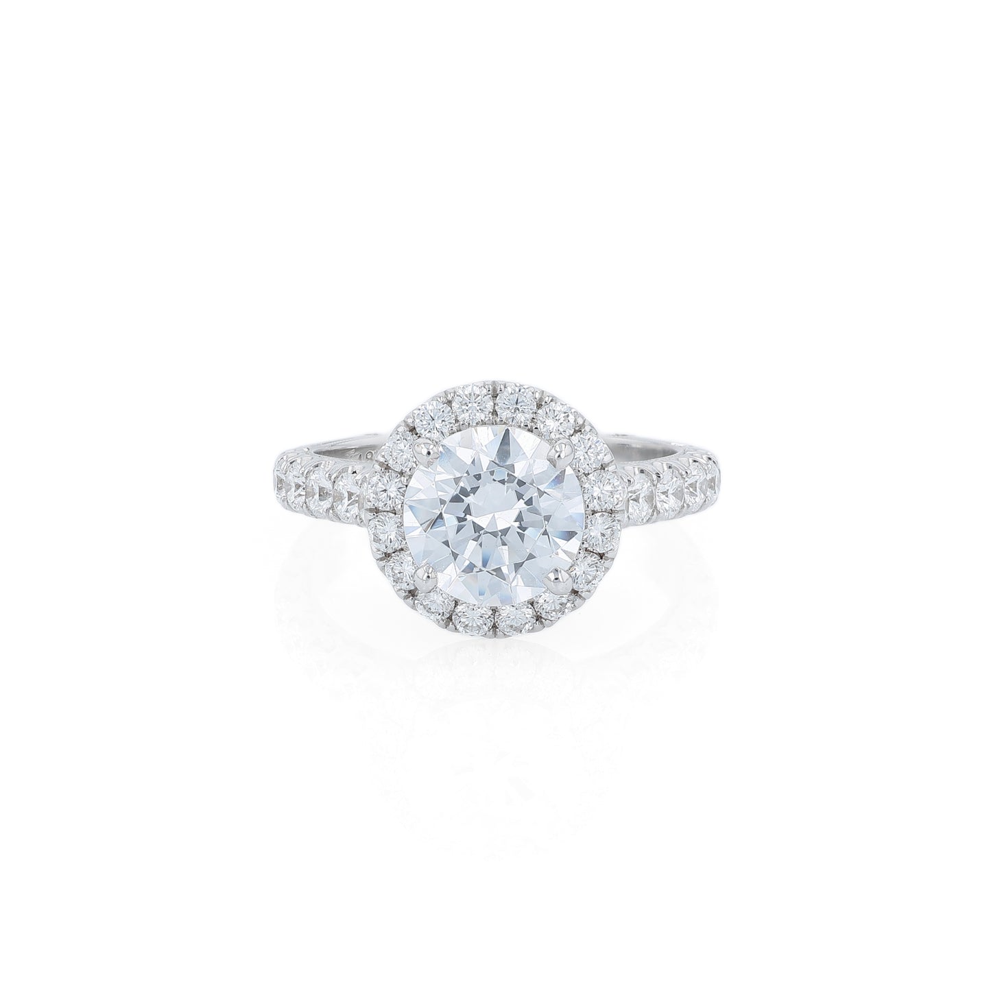 White gold diamond halo engagement ring with diamond accents and a round cubic zirconia center on a white background