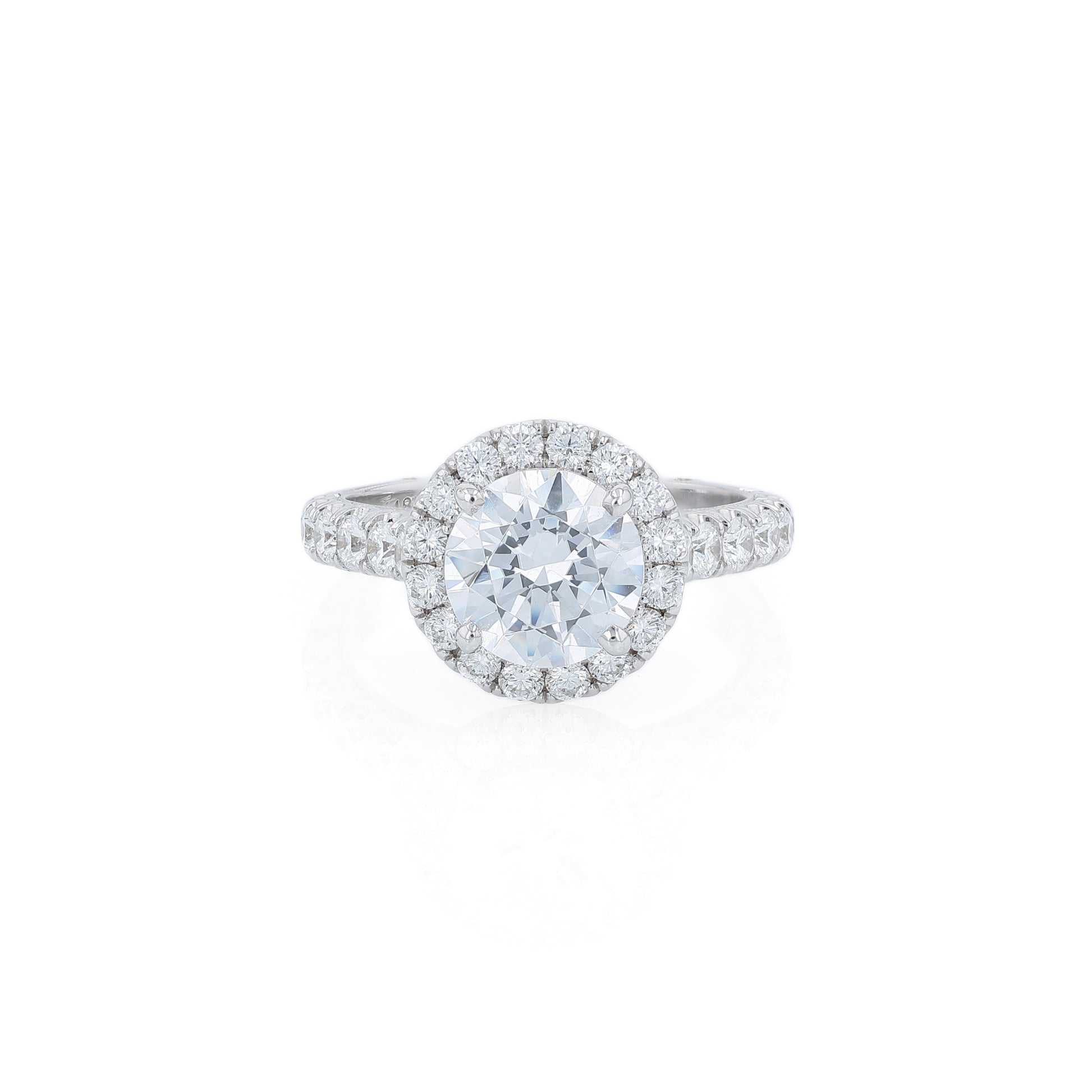 White gold diamond halo engagement ring with diamond accents and a round cubic zirconia center on a white background