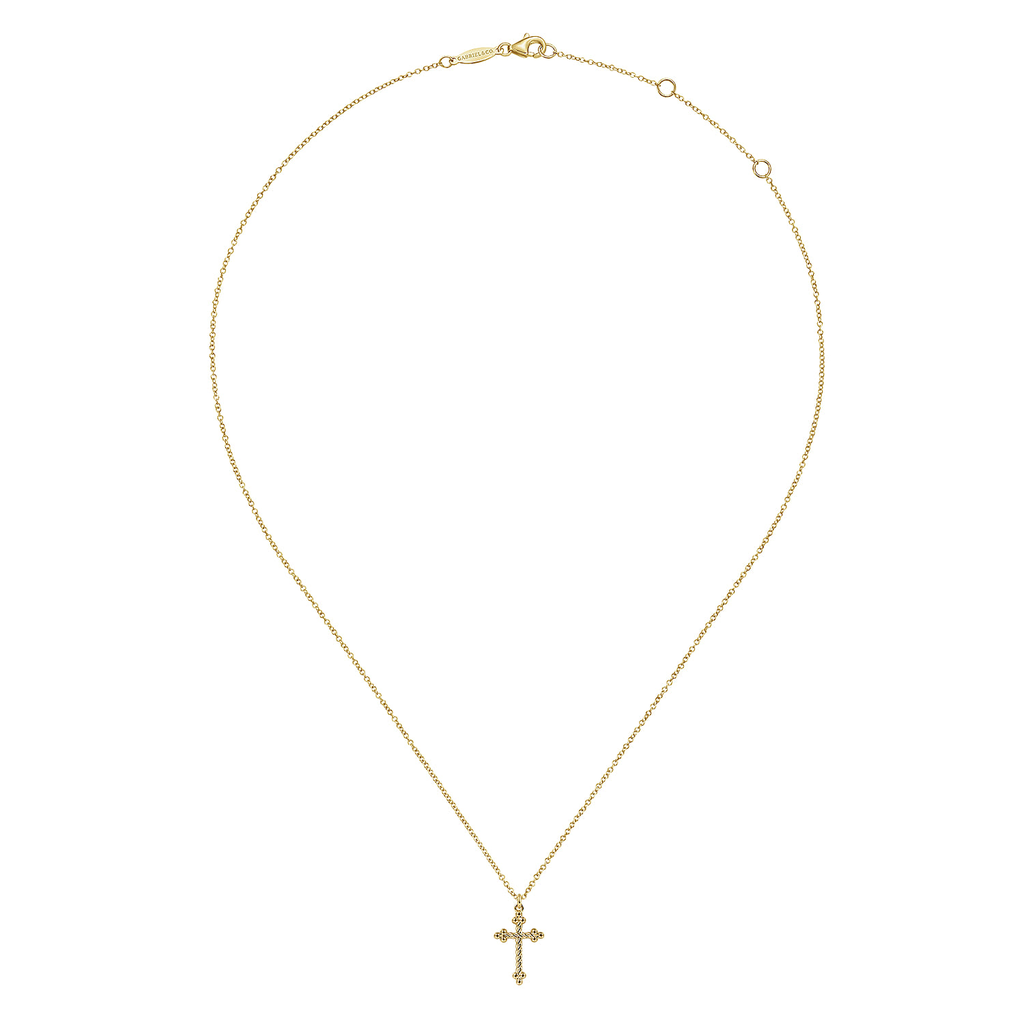 Gold necklace with a cross pendant on a white background