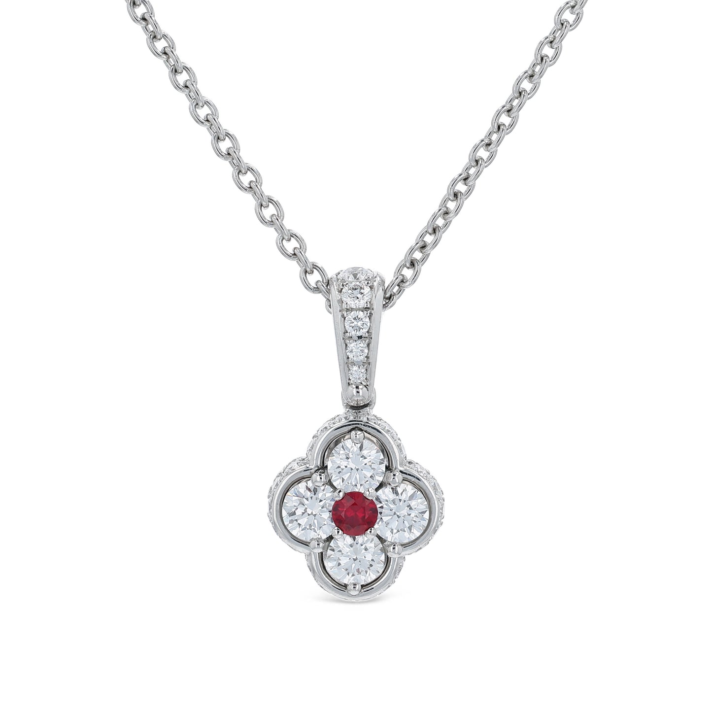 Platinum diamond and ruby pendant on a chain against a white background