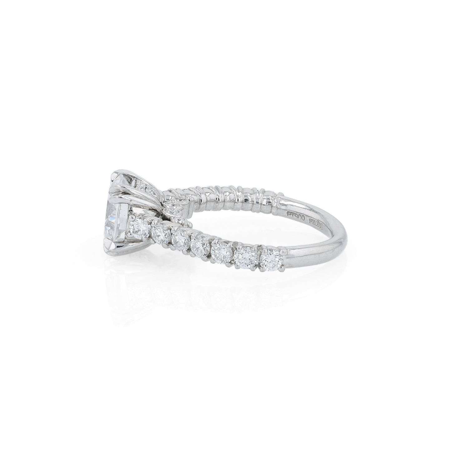 Platinum diamond engagement ring with diamond accents and a round cubic zirconia center on a white background