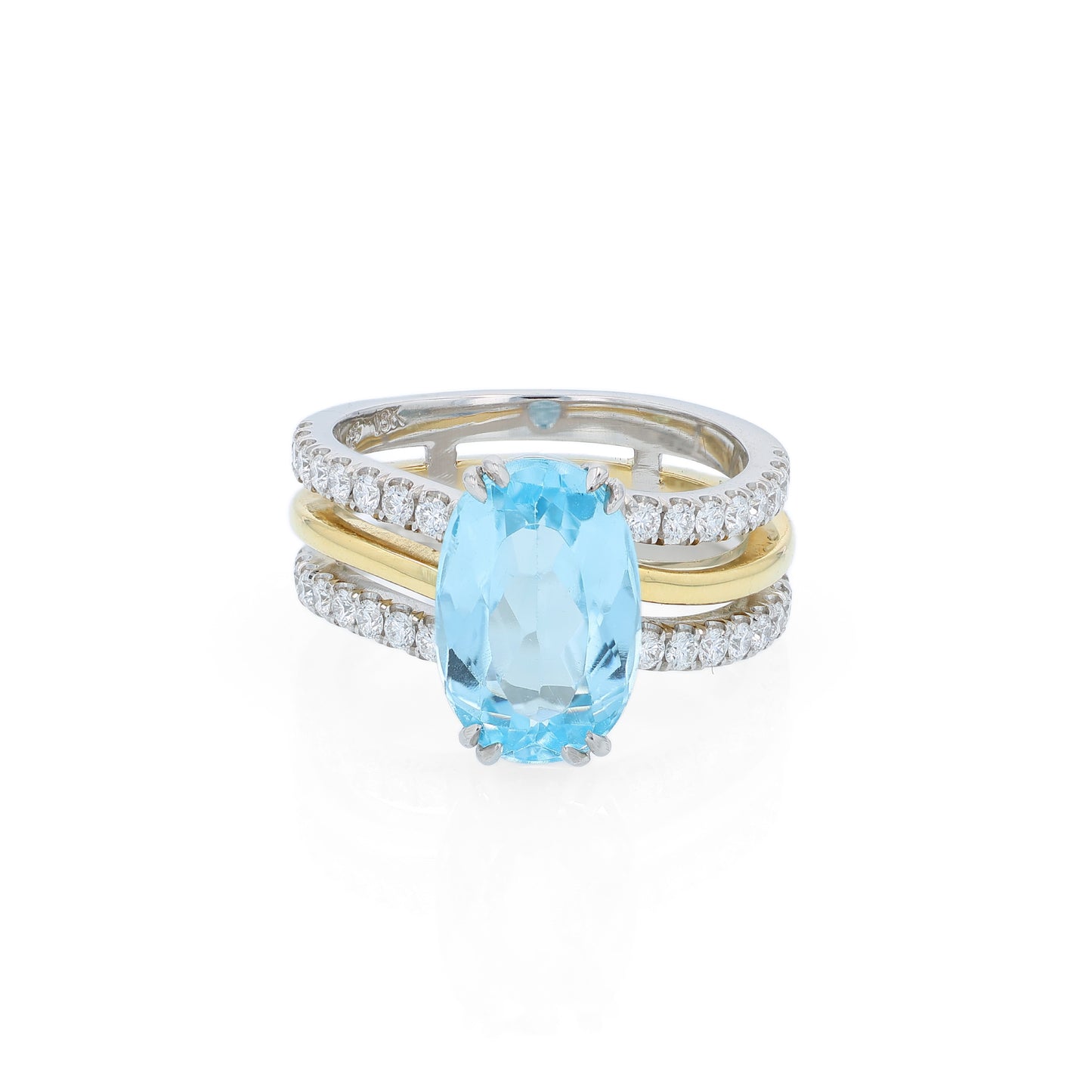 Two-tone ring with an oval swiss blue topaz center and diamond accents on a white background