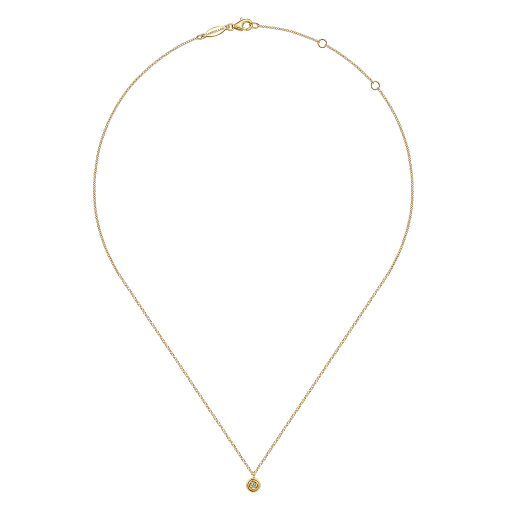 Gold necklace with a small pendant on a white background