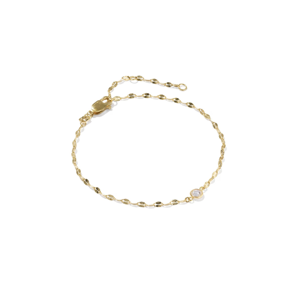 A delicate gold chain bracelet with a small round white gemstone accent, displayed on a clean white background.