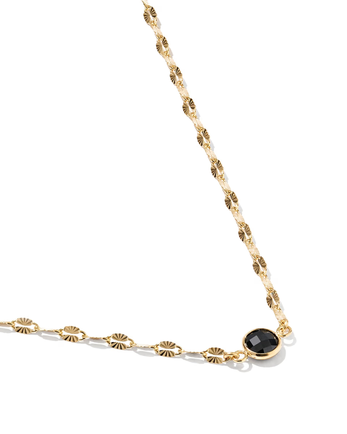 A gold chain necklace featuring textured sunburst links and a round black faceted gemstone pendant, shown on a clean white background.