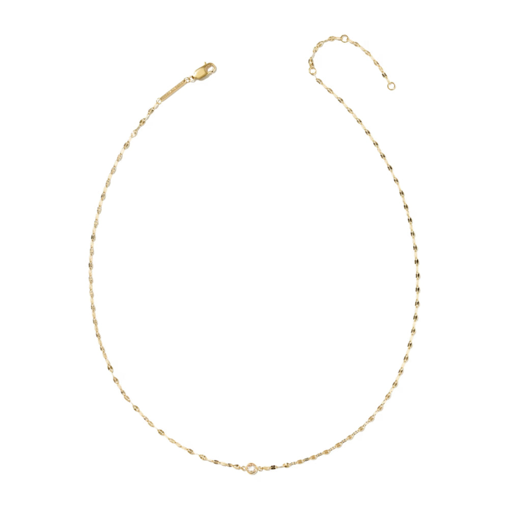 A delicate gold chain necklace with a small central clear crystal, displayed on a clean white background.