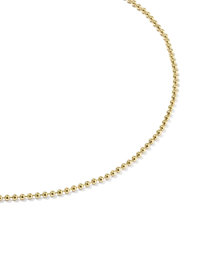 A close-up of a gold beaded chain anklet on a clean white background.