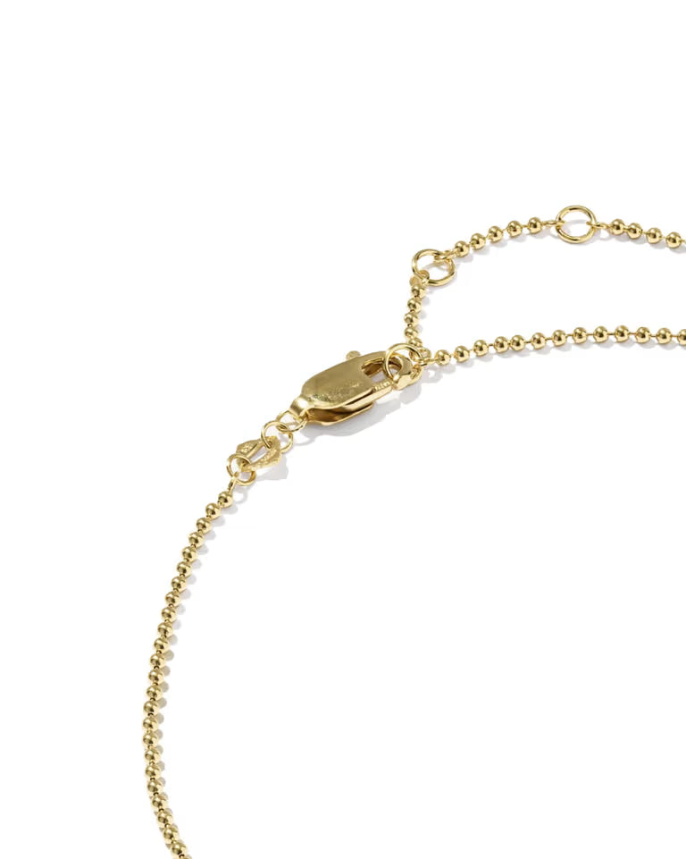 Close-up of a gold beaded chain anklet with a lobster clasp and adjustable ring, shown on a clean white background.