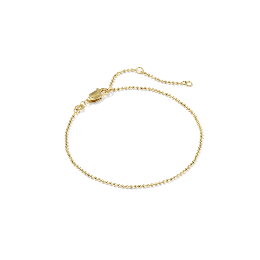 A delicate gold beaded chain bracelet with a lobster clasp and extender chain, displayed on a clean white background.
