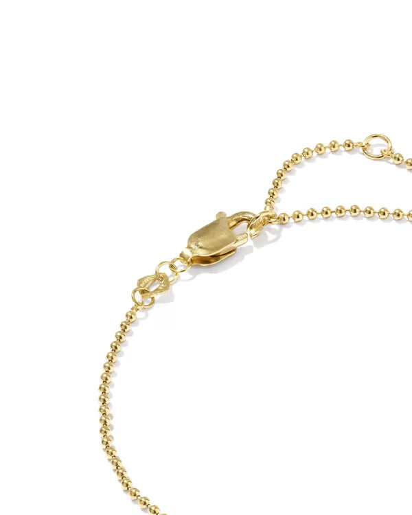 Close-up of a gold ball chain bracelet with a lobster clasp and adjustable slider ring on a white background.