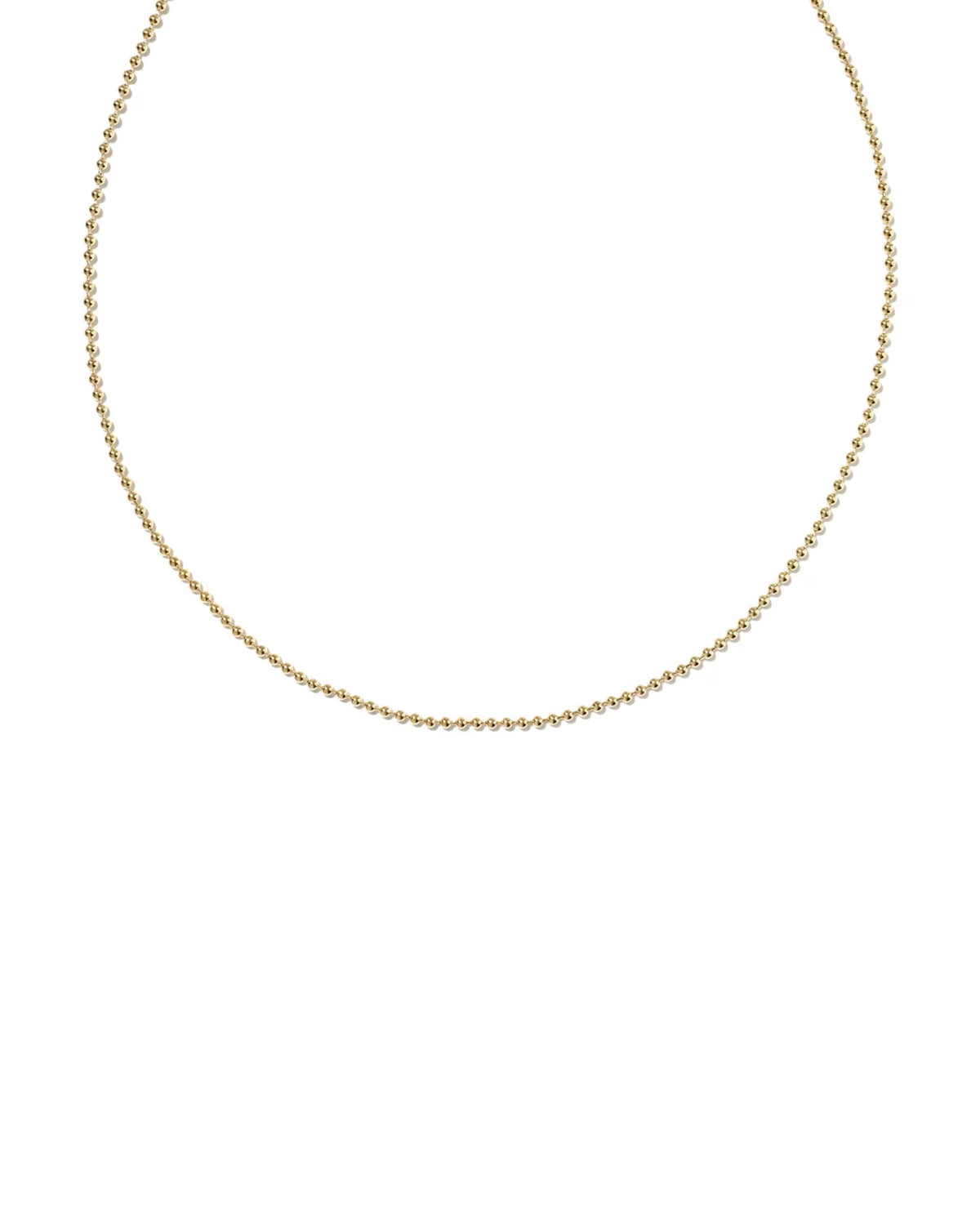 A delicate gold chain necklace with a textured, beaded appearance, displayed in a curved shape against a solid white background.