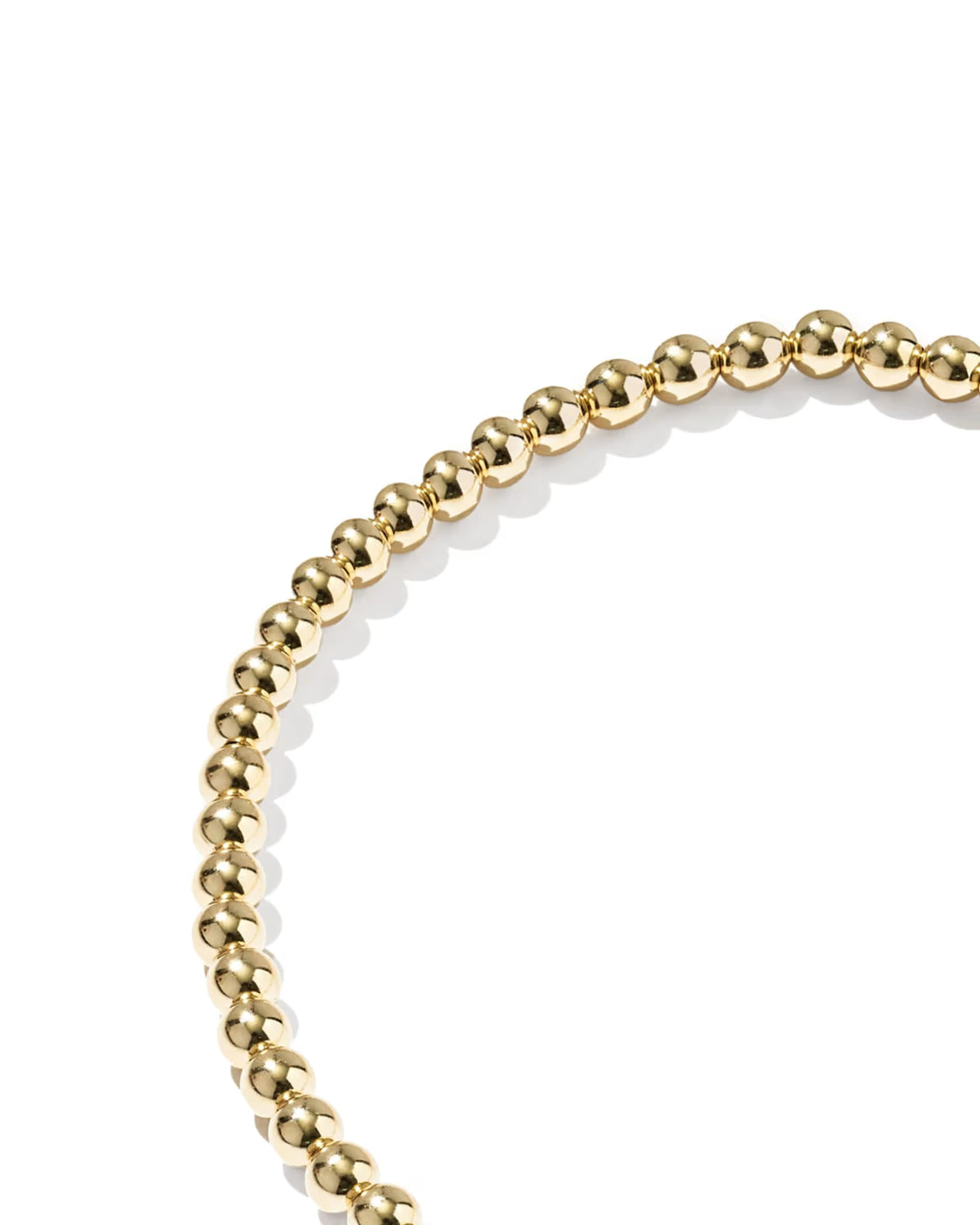 A close-up of a gold beaded bracelet on a clean white background.