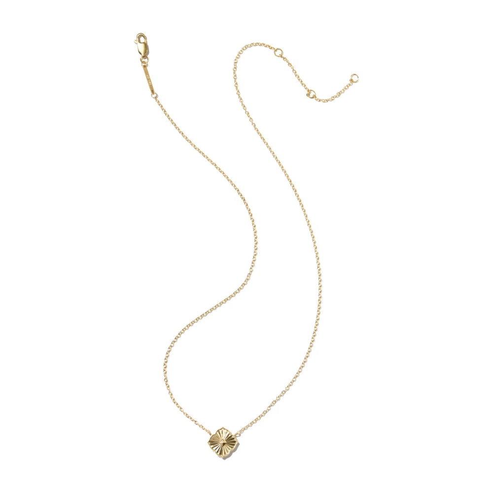 A delicate gold chain necklace featuring a small, textured gold clover pendant, displayed on a clean white background.