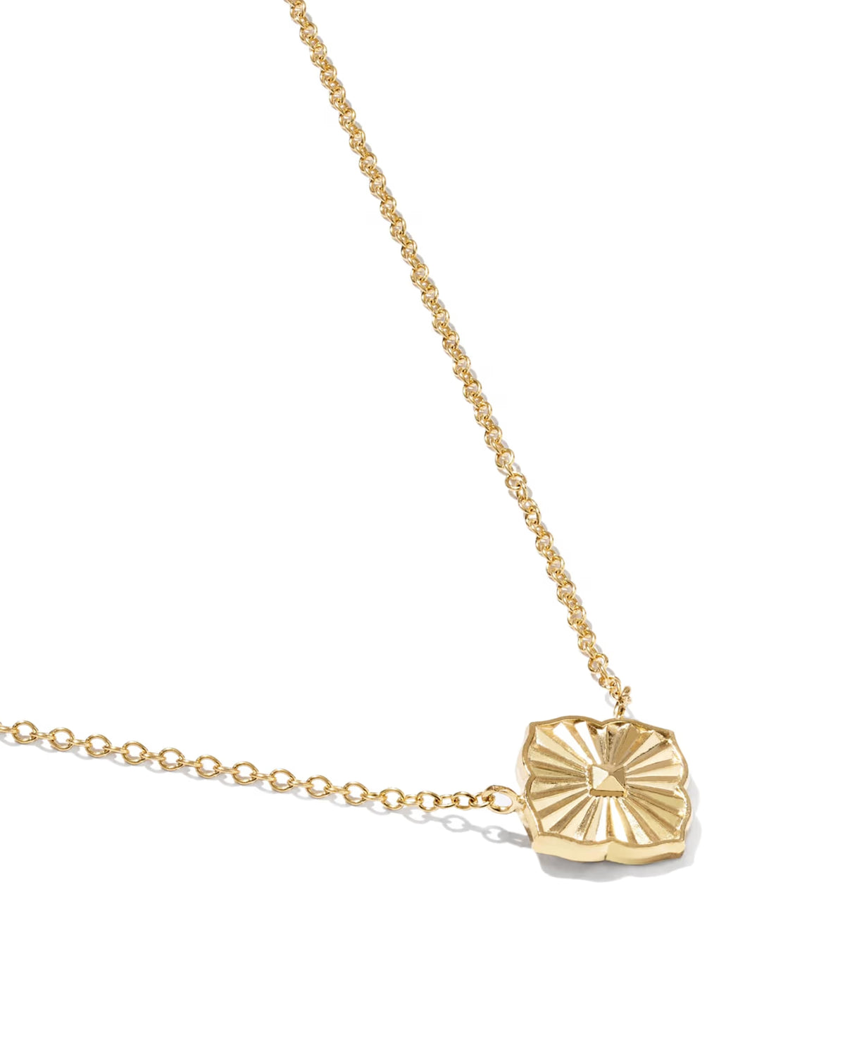 A delicate gold chain necklace featuring a textured, fan-like oval pendant, photographed on a clean white background.