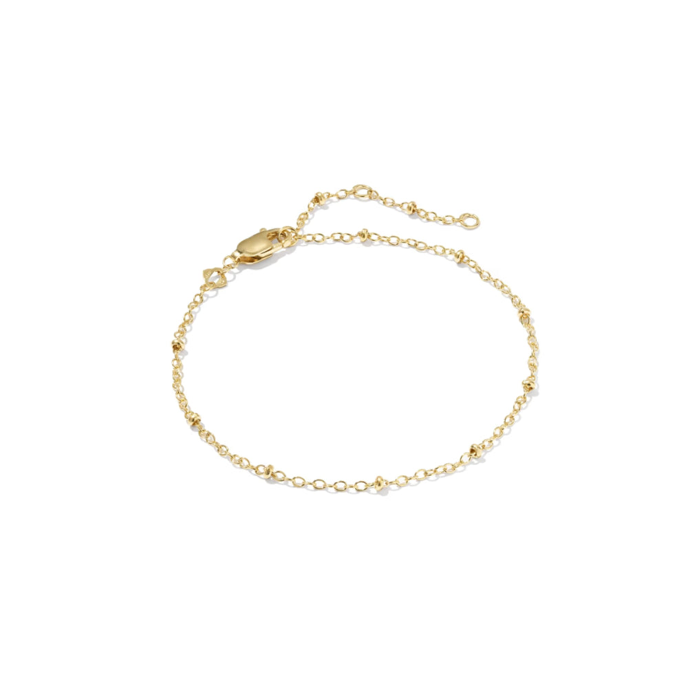 A delicate gold chain bracelet with small bead accents and an extender chain with lobster clasp, shown on a plain white background.