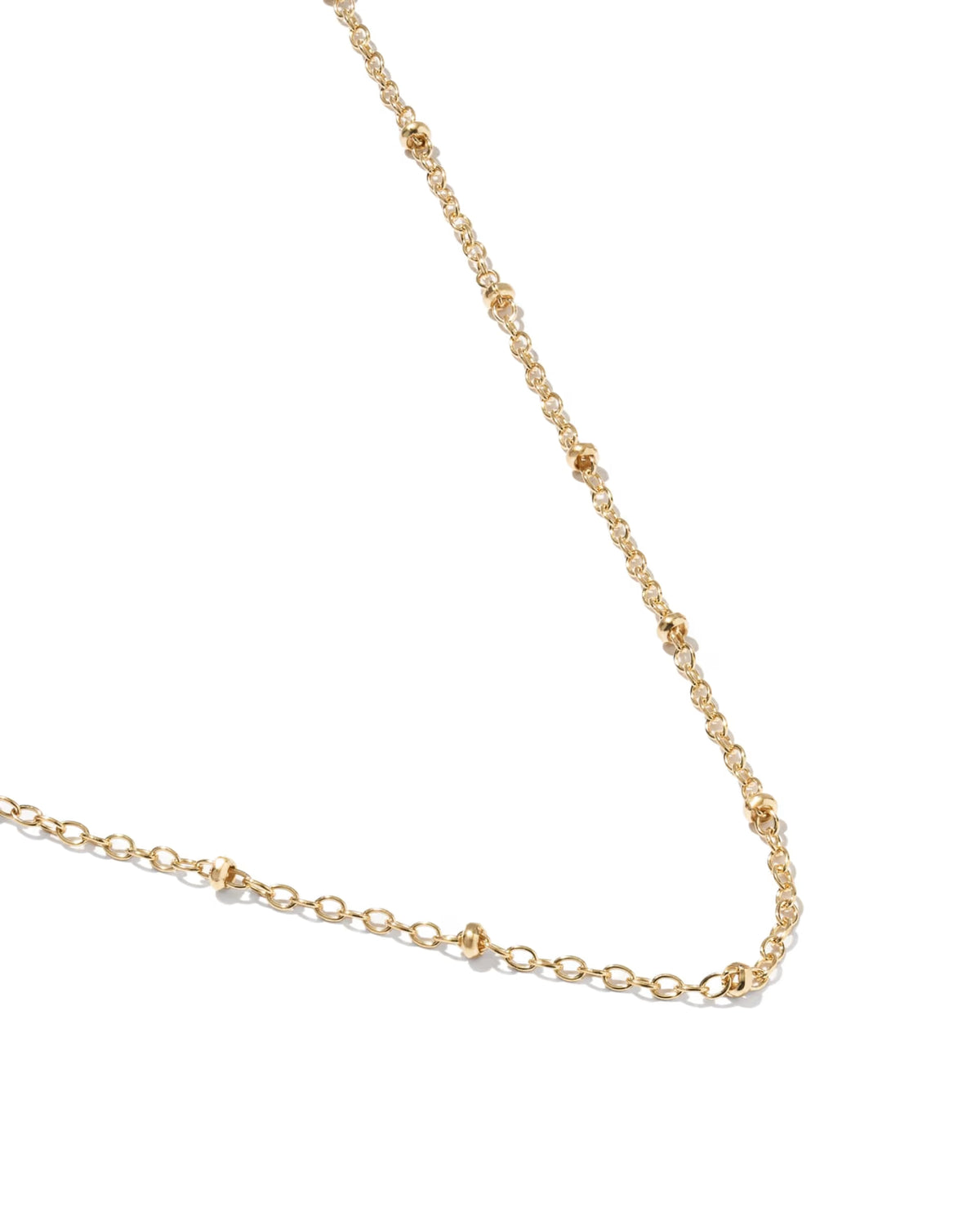 A delicate gold chain necklace featuring small, evenly spaced polished bead links, displayed on a clean white background.