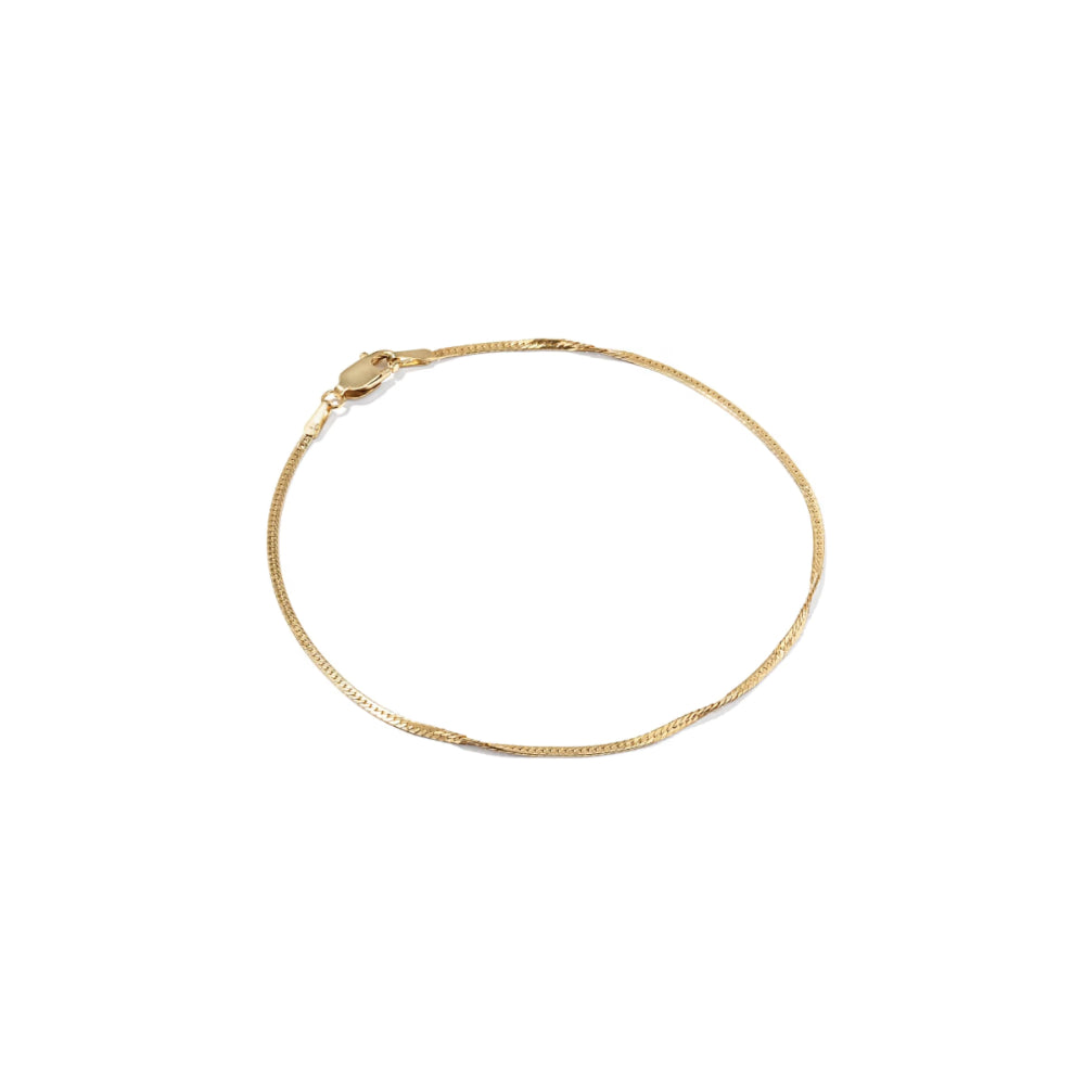 A delicate gold chain bracelet with a lobster clasp, displayed in a loose circle on a solid white background.