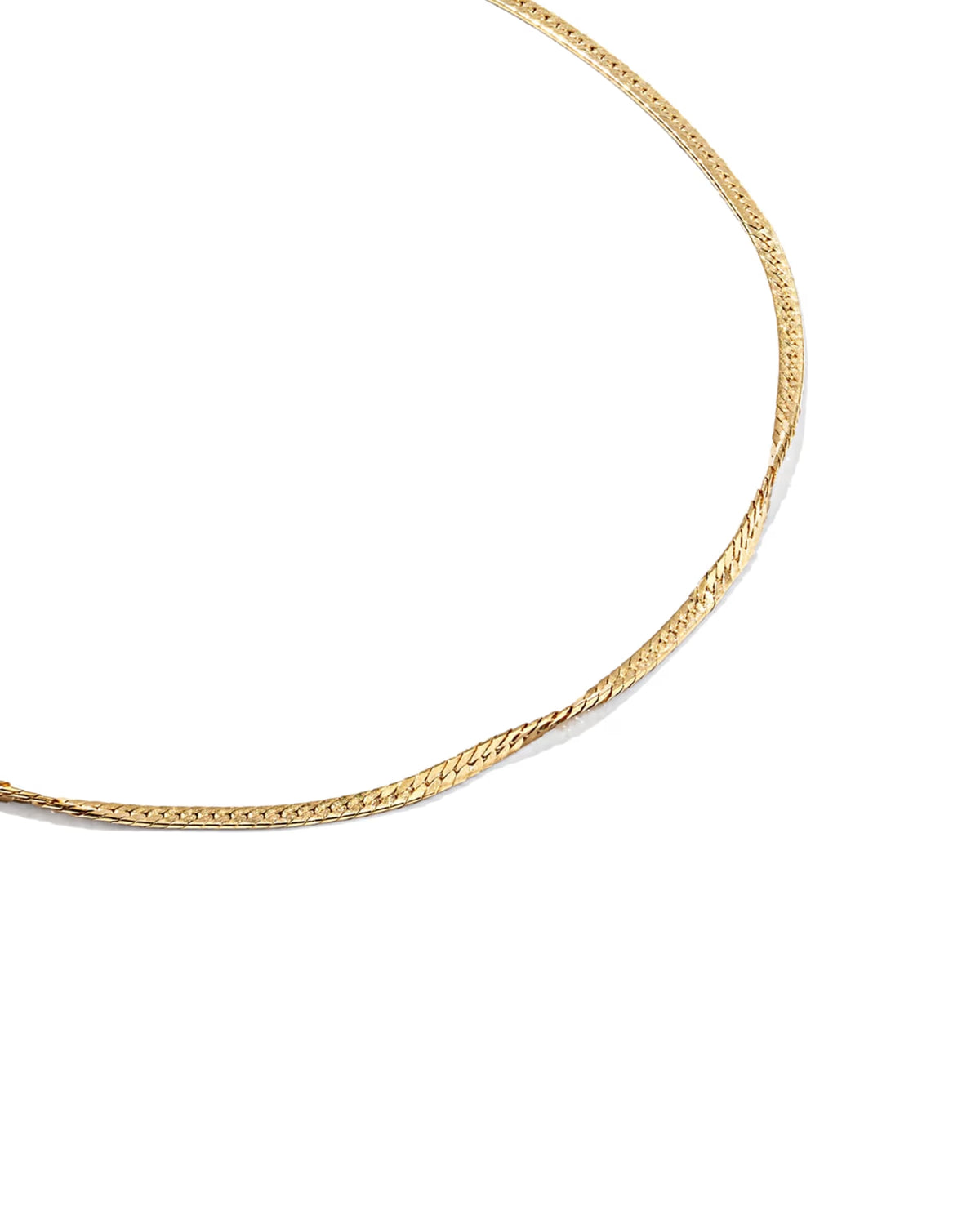 A close-up of a gold chain bracelet on a plain white background.