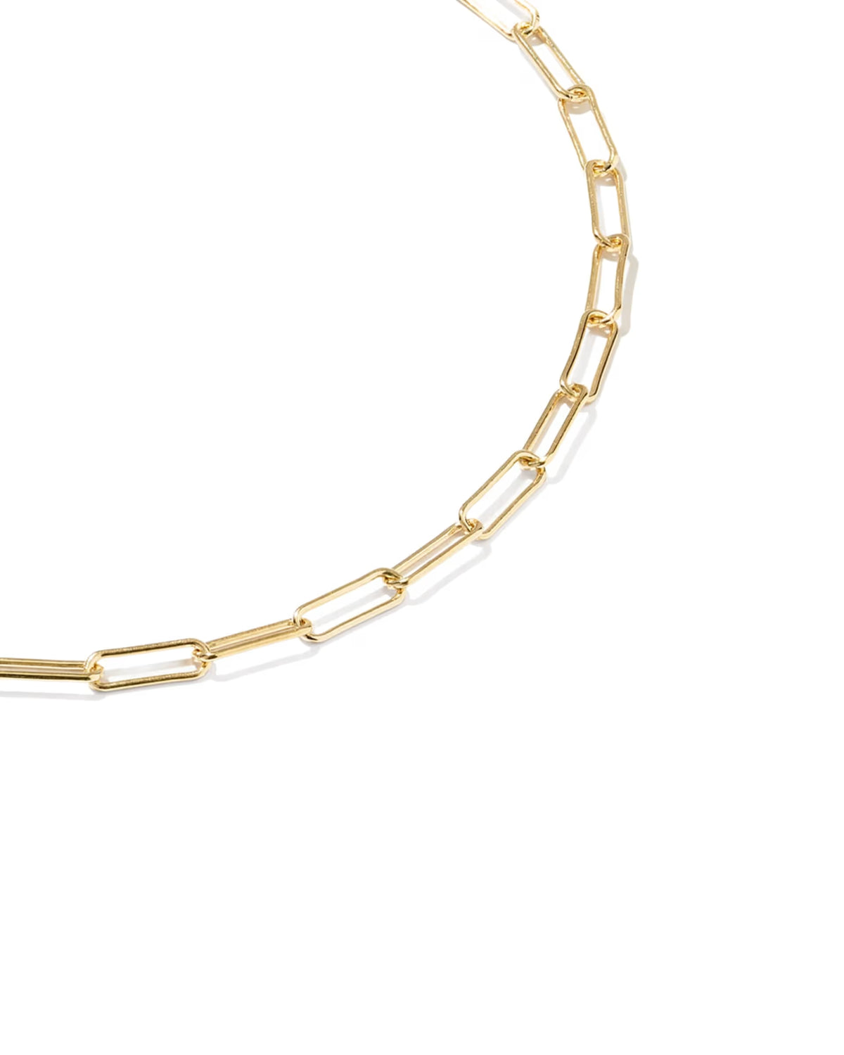 A close-up of a gold paperclip chain bracelet on a clean white background.