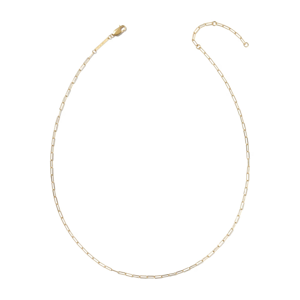 A delicate gold paperclip chain necklace with a lobster clasp and extender, displayed on a clean white background.