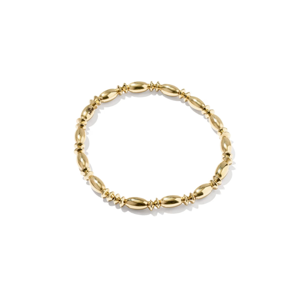 A gold beaded stretch bracelet with alternating polished oval beads and textured spacer links, displayed on a clean white background.