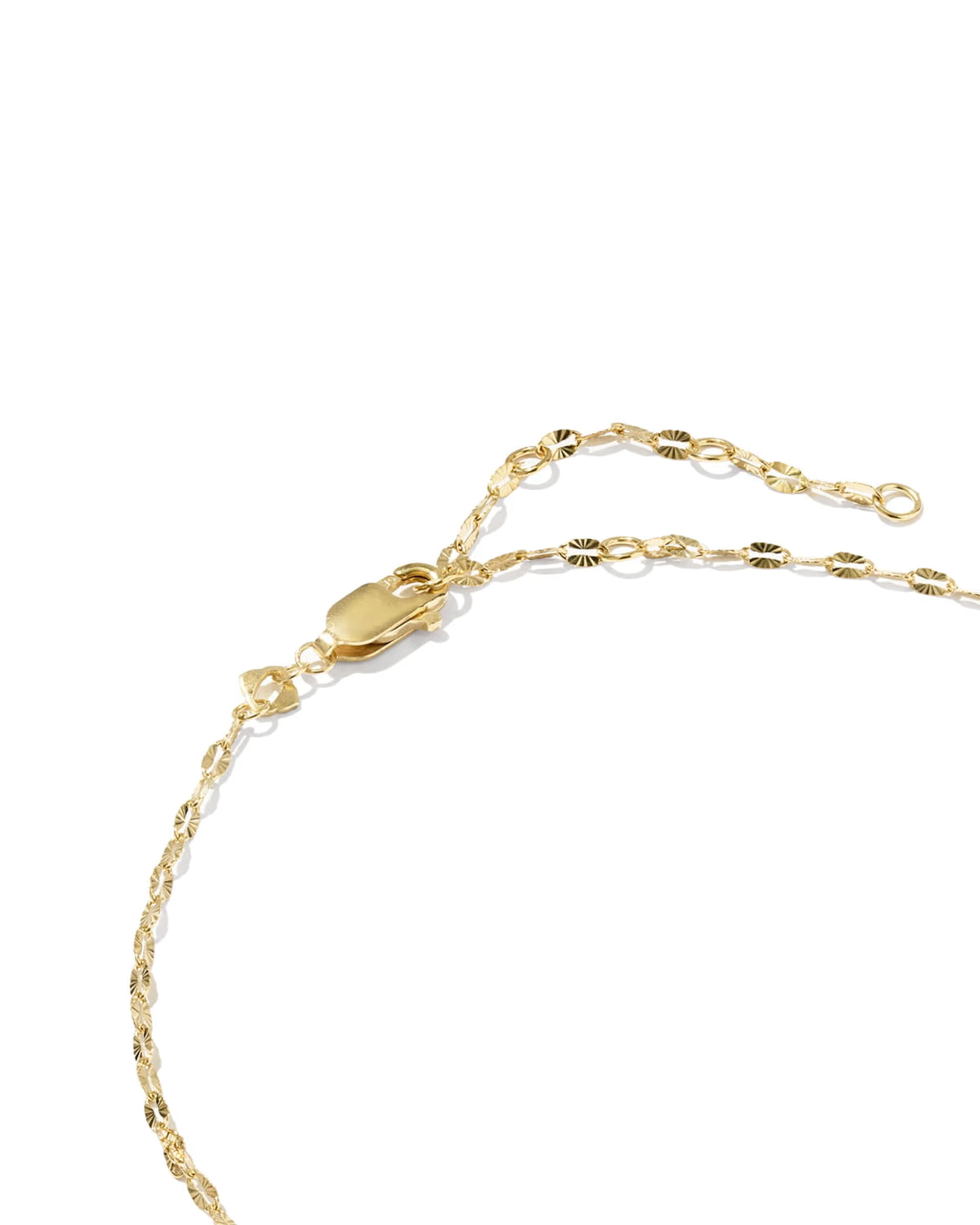 Close-up of a gold chain anklet with a lobster clasp and extender links on a plain white background.