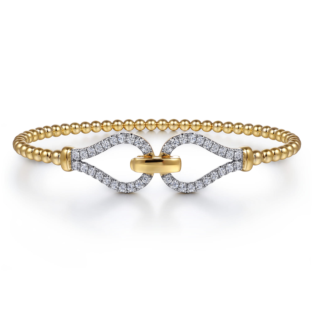gold beaded stirrup bangle bracelet with clear stones on white background