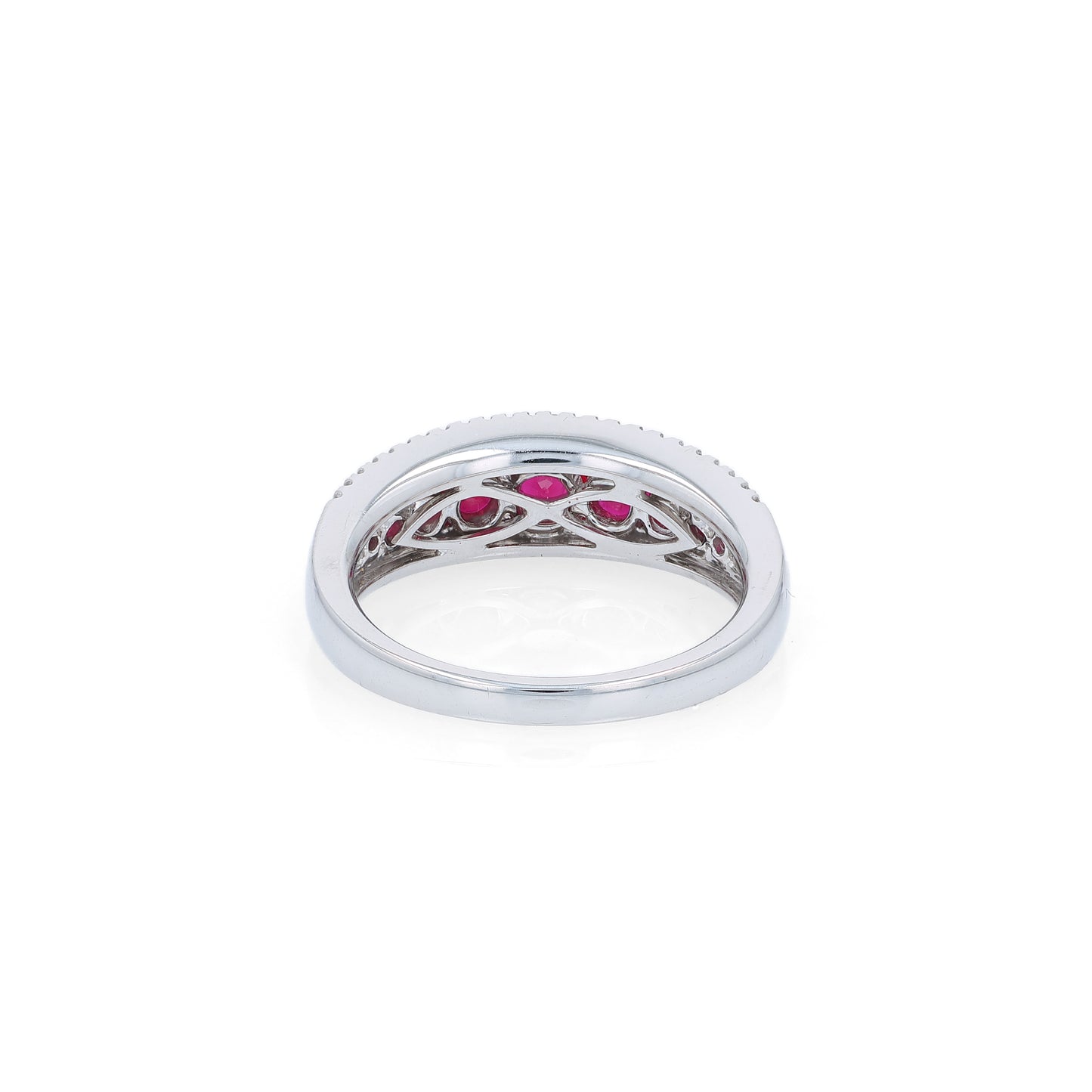 White gold ring with rubies and diamonds on a white background