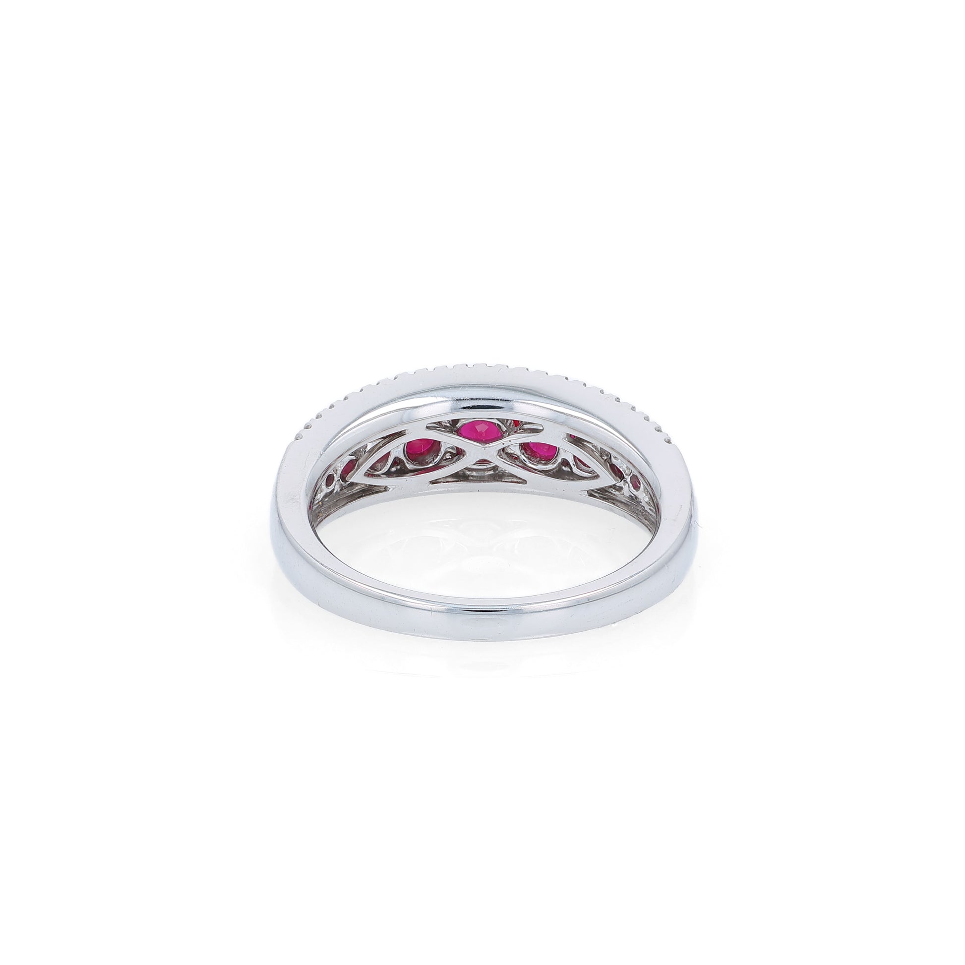 White gold ring with rubies and diamonds on a white background